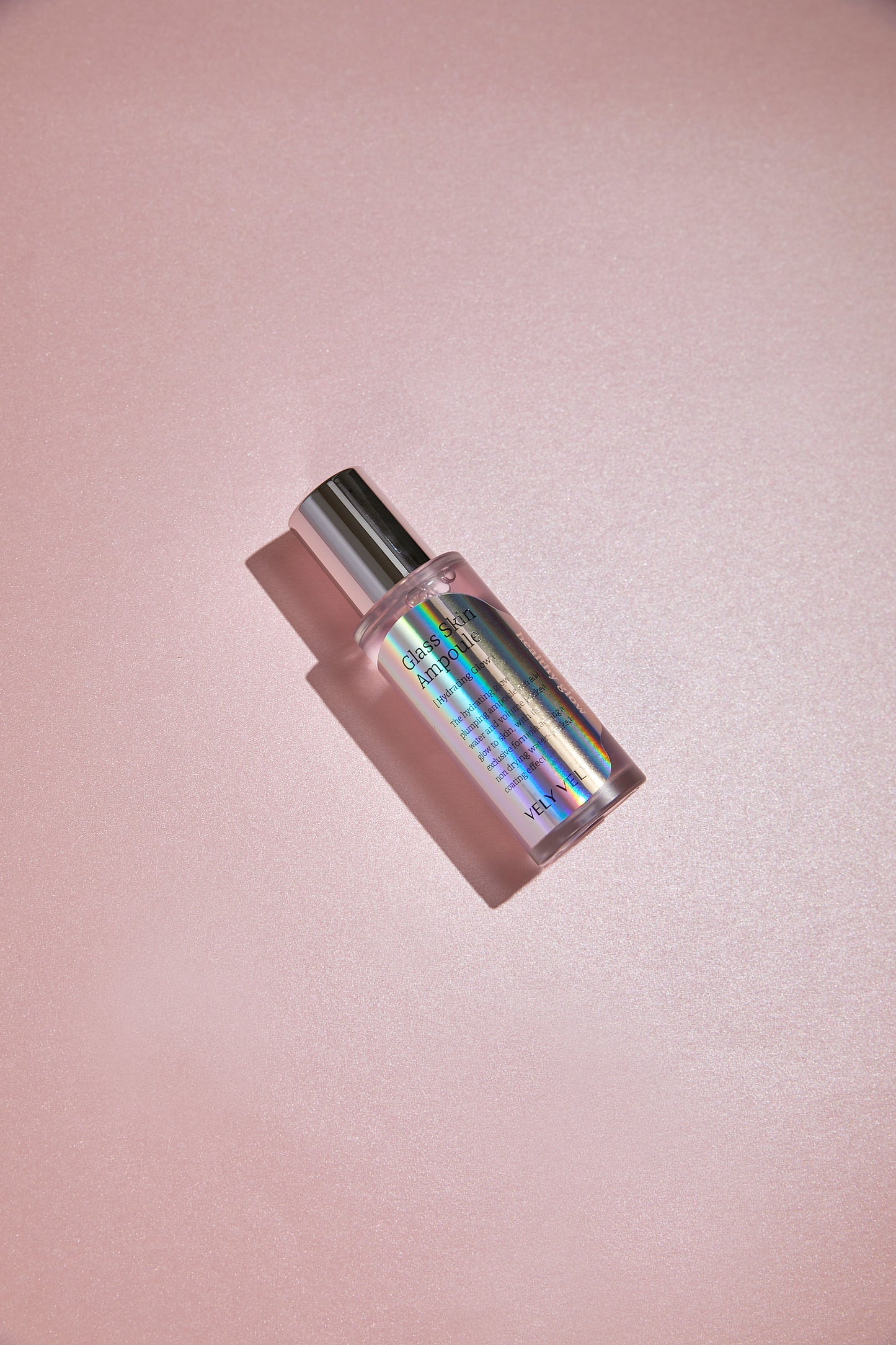 VELY VELY Glass Skin Ampoule 40ml on a pink surface, showcasing its hydrating and brightening formula.
