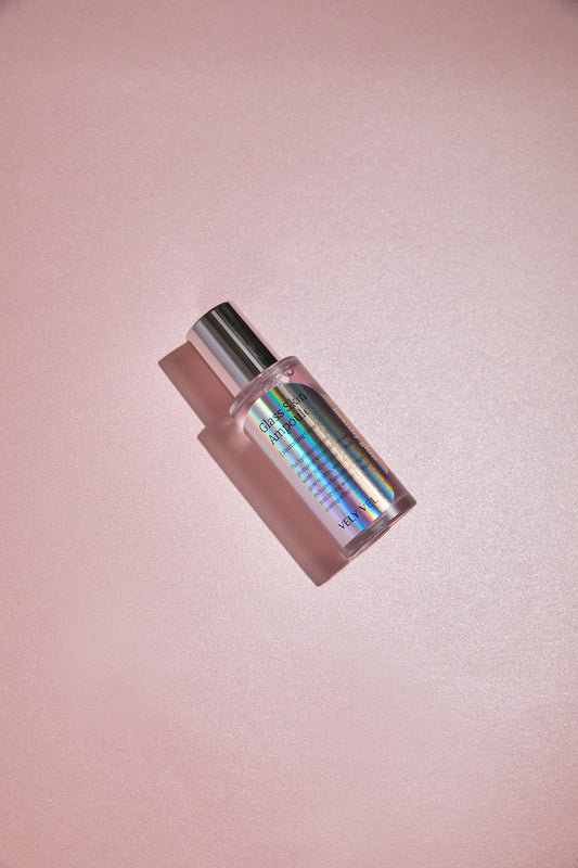 VELY VELY Glass Skin Ampoule 40ml on a pink surface, showcasing its hydrating and brightening formula.