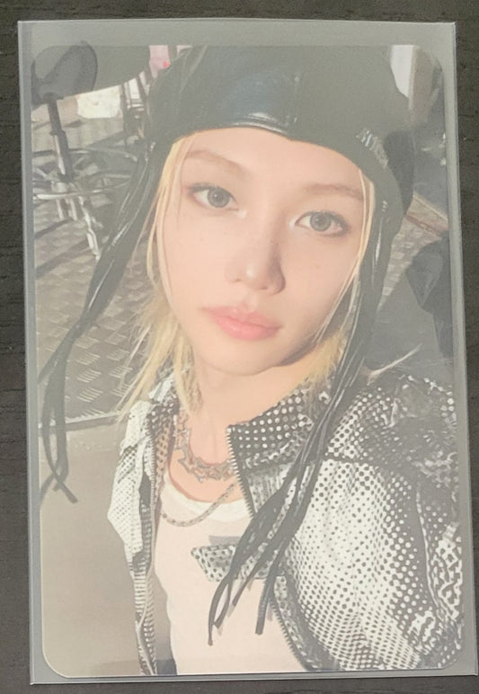 Close-up of a K-POP star's photocard, showcasing their stylish outfit and captivating expression.
