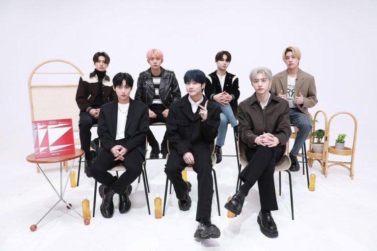 ENHYPEN members seated in a studio, showcasing their style for the article ENHYPEN – [THE SIN : VANISH].