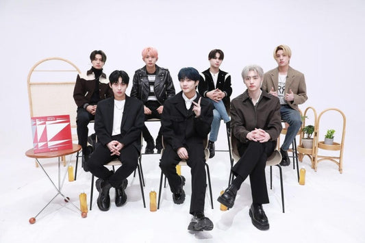 ENHYPEN members seated in a studio, showcasing their style for the article ENHYPEN – [THE SIN : VANISH].