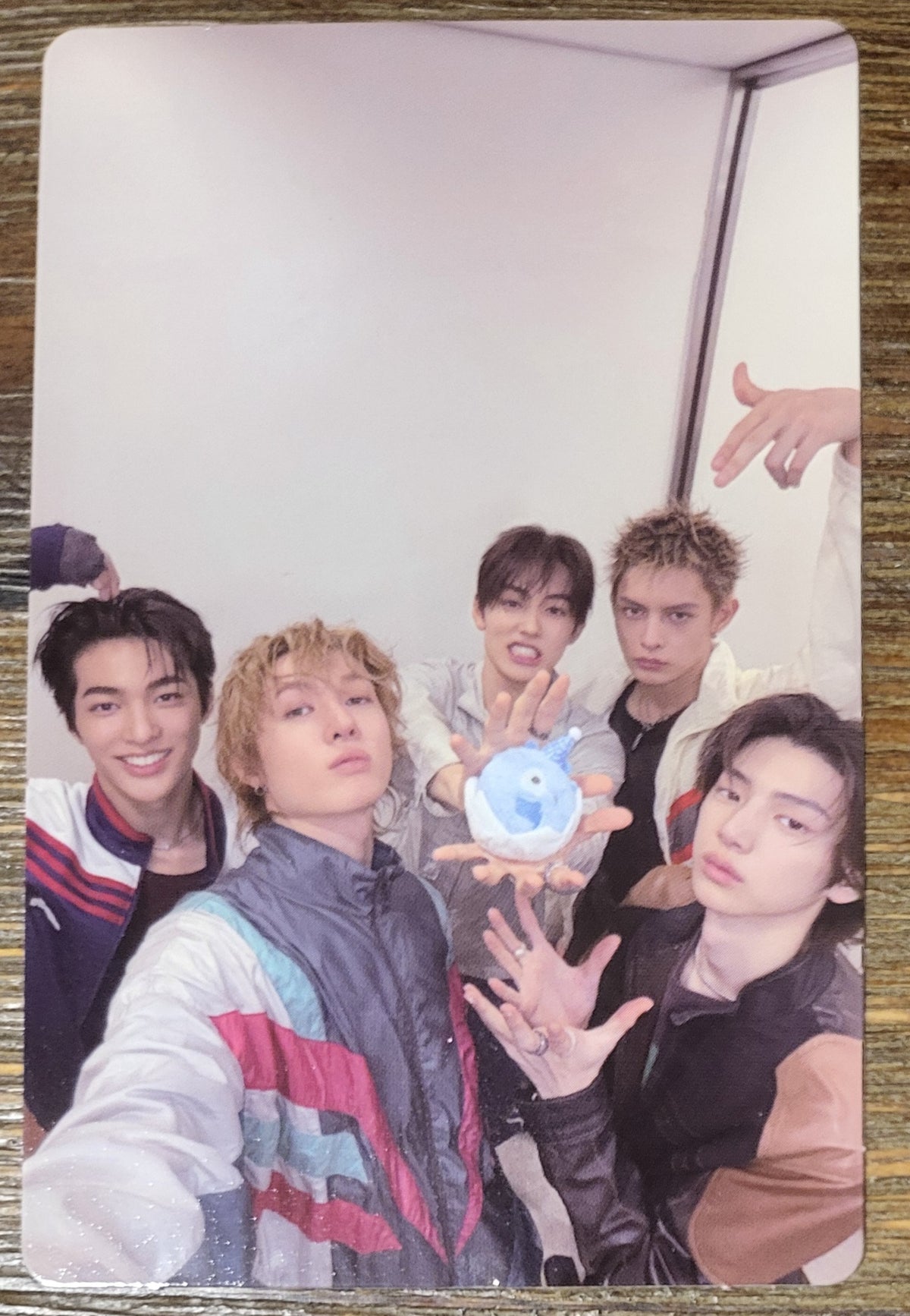 CORTIS official photocard featuring five members posing with a blue ball, showcasing the GREENGREEN_playextended concept.