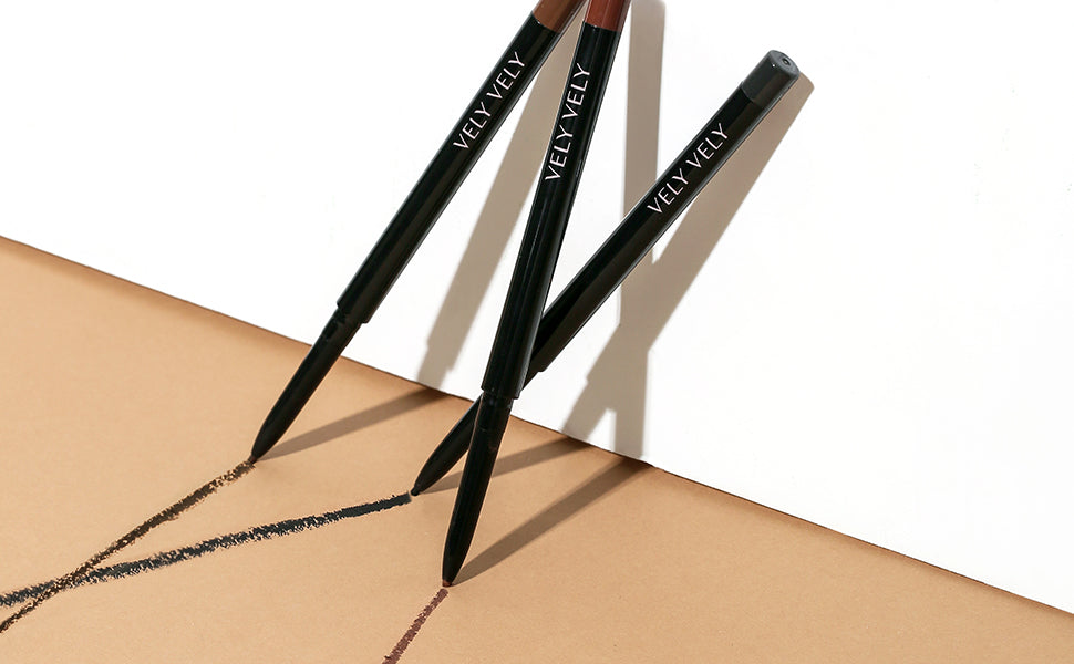 VELY VELY Super Slim Eyeliner pencils in various shades creating smooth lines on brown paper.