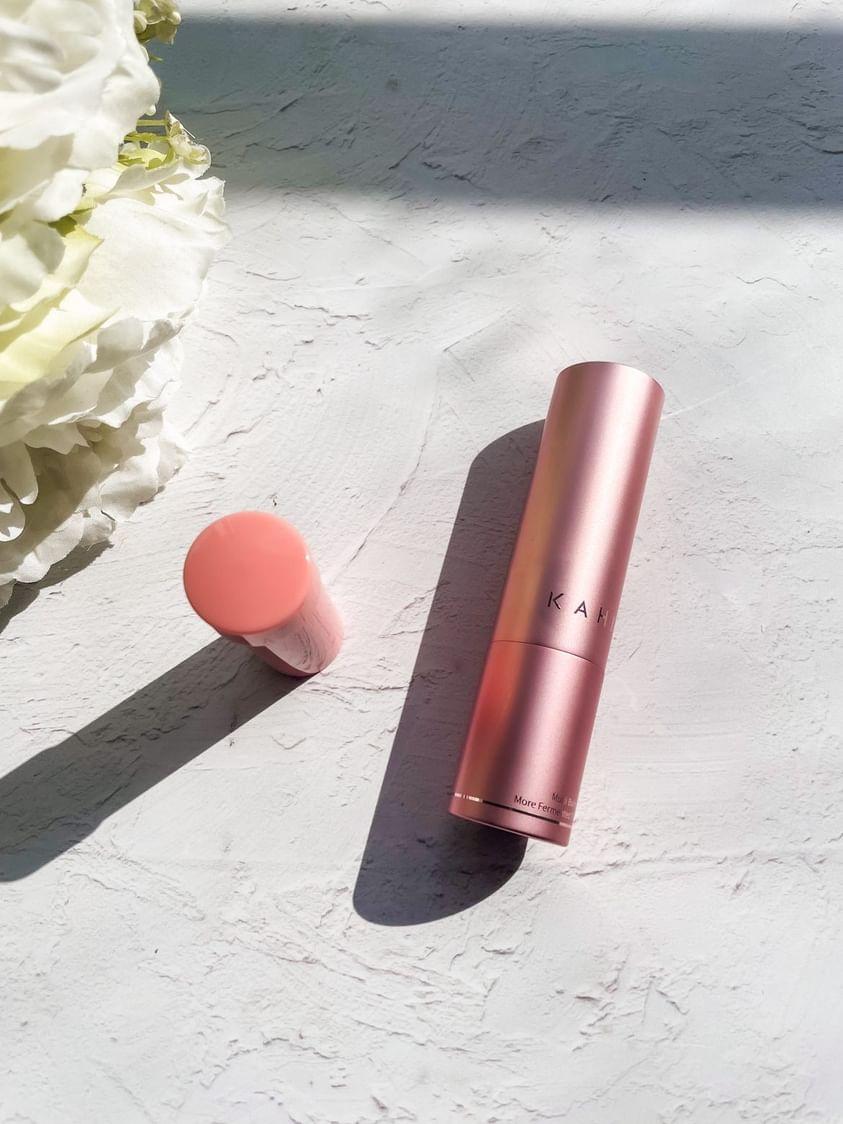 KAHI wrinkle multi balm and refill set in rose gold packaging on a textured surface, showcasing Korean skincare for glow and glass skin.